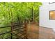 A wood deck offers great views of the surrounding lush, green trees at 165 River North Walk, Atlanta, GA 30328