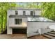 Unique home exterior with a flat roof section and large glass greenhouse feature at 165 River North Walk, Atlanta, GA 30328