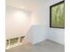 Hallway with a modern window, stairs, and a view of the surrounding greenery at 165 River North Walk, Atlanta, GA 30328