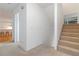 Hallway with carpet, stairway, and a glimpse into the kitchen, creating a seamless flow at 165 River North Walk, Atlanta, GA 30328