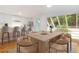 Modern kitchen and dining area with bar stools, natural light, and a large table at 165 River North Walk, Atlanta, GA 30328