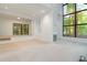 Spacious living room featuring neutral carpet, large windows, and natural light at 165 River North Walk, Atlanta, GA 30328