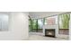 Bright living room with a modern fireplace and expansive windows showcasing nature at 165 River North Walk, Atlanta, GA 30328