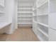 Custom white shelving and desk offer ample storage and a dedicated workspace at 165 River North Walk, Atlanta, GA 30328