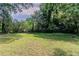 This backyard is spacious with lush greenery and a wooded border, offering a private outdoor space at 1906 Oak Valley Rd, Decatur, GA 30035