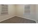 Bedroom with neutral walls, carpet floors, base board trim, and two windows with blinds at 1906 Oak Valley Rd, Decatur, GA 30035