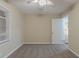 Bedroom featuring neutral walls, carpeted floors, base board trim, a bright white door and ceiling fan at 1906 Oak Valley Rd, Decatur, GA 30035