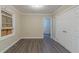 A bedroom featuring hard wood floors, neutral walls, base board trim and bright white doors at 1906 Oak Valley Rd, Decatur, GA 30035