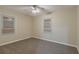 Bedroom with neutral walls, carpeted floors, base board trim, two windows and a ceiling fan at 1906 Oak Valley Rd, Decatur, GA 30035