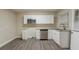 The modernized kitchen features stainless steel appliances, granite countertops, and white cabinets at 1906 Oak Valley Rd, Decatur, GA 30035