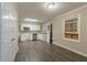 Open kitchen space with new stainless steel appliances, white cabinetry, and a hard wood floor at 1906 Oak Valley Rd, Decatur, GA 30035