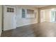 Inviting room with new gray vinyl floors, natural light, and an open doorway to another room at 1906 Oak Valley Rd, Decatur, GA 30035