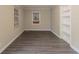 Neat room featuring new gray vinyl floors, a freshly painted interior, built-in shelves, and natural light at 1906 Oak Valley Rd, Decatur, GA 30035