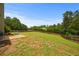 A spacious backyard features a concrete patio, a green picnic table, a wooden fence and mature trees, creating a private oasis at 237 Arborview Dr, Mcdonough, GA 30252
