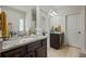 Bathroom showcasing dual vanities, granite countertop, dark cabinets, and modern fixtures at 237 Arborview Dr, Mcdonough, GA 30252