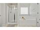 Bathroom features a soaking tub, glass-enclosed shower, and neutral tile at 237 Arborview Dr, Mcdonough, GA 30252