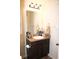 Bathroom vanity with dark wood cabinets, granite countertop, and decorative accents at 237 Arborview Dr, Mcdonough, GA 30252