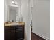 Small bathroom with single sink vanity with granite countertop and dark cabinets at 237 Arborview Dr, Mcdonough, GA 30252