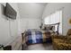 This bedroom features a cozy bed, a TV, and a comfortable armchair, creating a relaxing and functional space at 237 Arborview Dr, Mcdonough, GA 30252