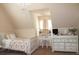 Cozy bedroom with slanted ceilings, chandelier, vanity desk, and ample natural light at 237 Arborview Dr, Mcdonough, GA 30252