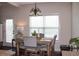 Sunlit dining area featuring a chandelier and a dining table with seating for four at 237 Arborview Dr, Mcdonough, GA 30252