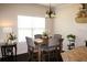 Inviting dining area with a chandelier, table for four, and view of the kitchen at 237 Arborview Dr, Mcdonough, GA 30252