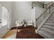 Inviting foyer with hardwood floors, staircase, and high ceilings creating an open and airy atmosphere at 237 Arborview Dr, Mcdonough, GA 30252