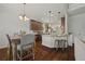Open-concept kitchen and dining area featuring granite countertops, stainless steel appliances, and hardwood floors at 237 Arborview Dr, Mcdonough, GA 30252