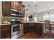 Well-equipped kitchen featuring stainless steel appliances, dark wood cabinets, and granite countertops at 237 Arborview Dr, Mcdonough, GA 30252
