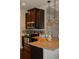 Kitchen with granite counters and stainless steel oven under dark wood cabinets at 237 Arborview Dr, Mcdonough, GA 30252