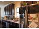 Contemporary kitchen features stainless steel appliances and dark wood cabinetry at 237 Arborview Dr, Mcdonough, GA 30252