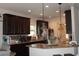 Modern kitchen with dark wood cabinetry, granite countertops, and stainless steel appliances at 237 Arborview Dr, Mcdonough, GA 30252
