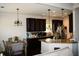 Well-lit kitchen with stainless steel appliances, dark wood cabinets, and open to the dining area at 237 Arborview Dr, Mcdonough, GA 30252
