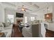 Inviting living room with fireplace, hardwood floors, and open concept layout into the kitchen at 237 Arborview Dr, Mcdonough, GA 30252