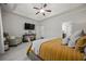 Spacious main bedroom with tray ceiling, ceiling fan, and large bed at 237 Arborview Dr, Mcdonough, GA 30252