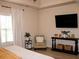 Bright and airy bedroom featuring hardwood floors, a tv and stylish decor at 237 Arborview Dr, Mcdonough, GA 30252