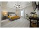 Spacious main bedroom featuring a tray ceiling, ceiling fan, and large bed at 237 Arborview Dr, Mcdonough, GA 30252