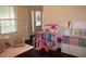 Inviting playroom with a dollhouse, toy storage, and natural light from large window at 237 Arborview Dr, Mcdonough, GA 30252