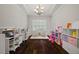Spacious playroom with hardwood floors, natural light, and ample space for activities and storage at 237 Arborview Dr, Mcdonough, GA 30252