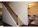 Carpeted staircase with stained wood railing in a home with neutral colors at 237 Arborview Dr, Mcdonough, GA 30252