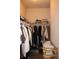 Walk-in closet with shelves, hanging rods and stacked clothing and shoes at 237 Arborview Dr, Mcdonough, GA 30252