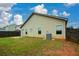 Large fenced backyard with green grass, offering plenty of space for outdoor enjoyment and relaxation at 2671 Calvary Dr, Hampton, GA 30228