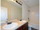 Bright bathroom featuring a double vanity, large mirror and tub with shower at 2671 Calvary Dr, Hampton, GA 30228
