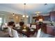 Dining room showcasing a chandelier, table with seating for eight, and hardwood floors at 2671 Calvary Dr, Hampton, GA 30228