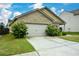 Home with an attached two-car garage, spacious driveway, and nicely landscaped front yard at 2671 Calvary Dr, Hampton, GA 30228