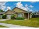 Inviting home featuring a manicured lawn, covered front porch, brick, and siding details at 2671 Calvary Dr, Hampton, GA 30228