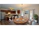 Eat-in kitchen featuring stainless steel appliances, granite countertops, and a stylish dining area at 2671 Calvary Dr, Hampton, GA 30228