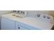 The laundry room has a white washer and dryer at 2671 Calvary Dr, Hampton, GA 30228