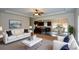 Open-concept living room seamlessly connects to a modern kitchen and dining area, ideal for entertaining at 2671 Calvary Dr, Hampton, GA 30228