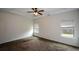 Spacious main bedroom features carpet, tray ceiling and natural light through multiple windows at 2671 Calvary Dr, Hampton, GA 30228